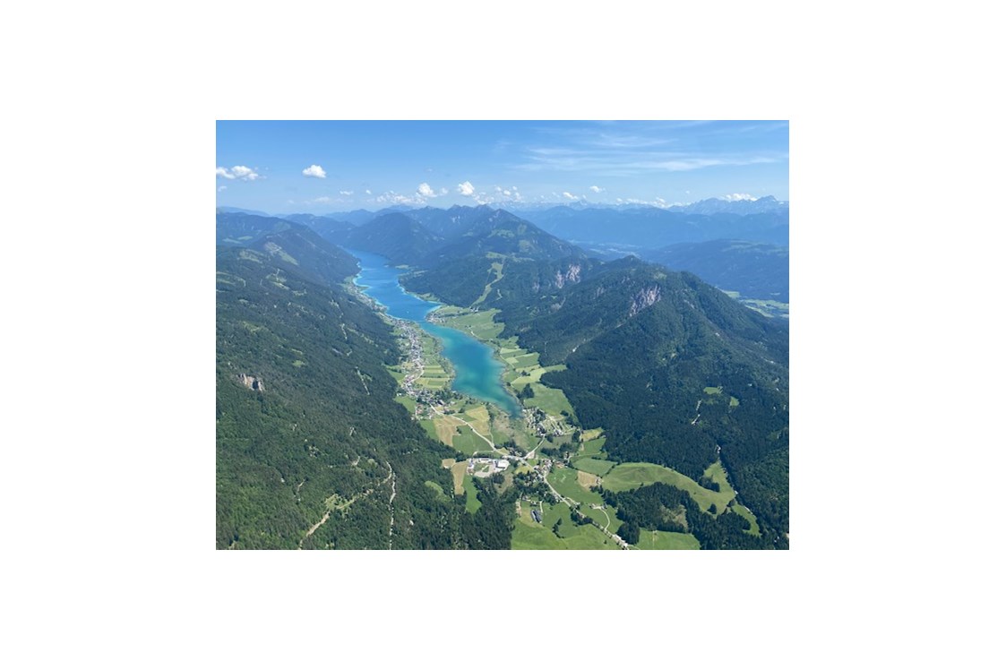 Wanderhotel: In 1.000 m Seehöhe - mit dem Gleitschirm  -
Blick auf den Weissensee  - Sattleggers Alpenhof & Feriensternwarte